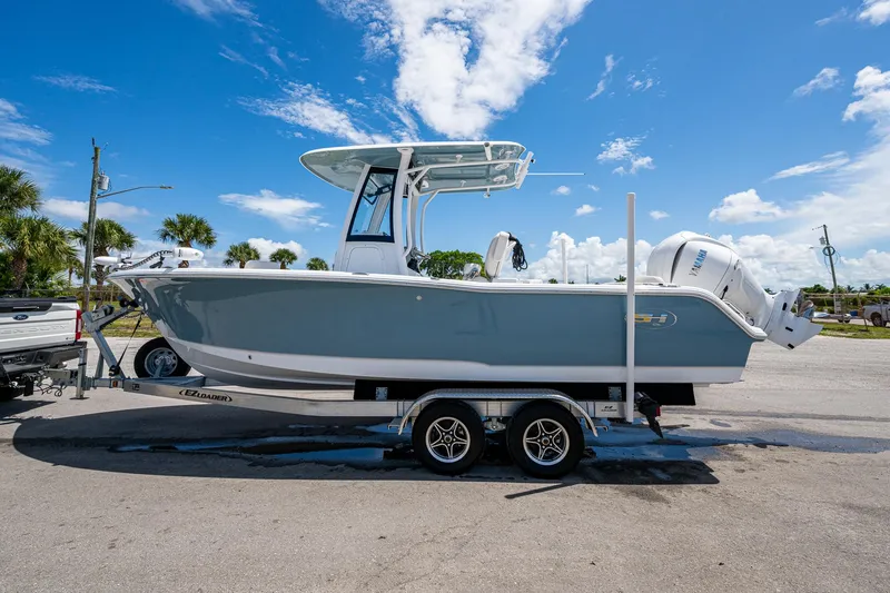 Slide: The Image of 2024 Sea Hunt Ultra 239 SE boat on trailer under clear blue sky. - 41
