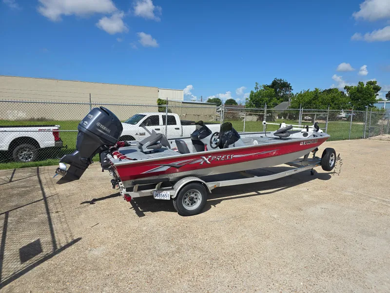 Slide: The Image of 2014 Xpress XP200 boat with Yamaha motor on trailer, parked outdoors under blue sky. - 3