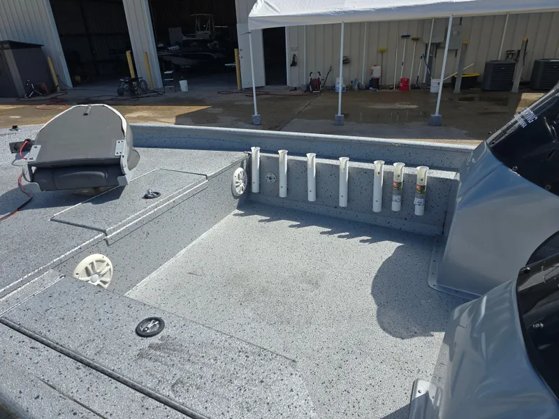Slide: The Image of 2014 Xpress XP200 boat interior with rod holders and storage compartments. - 9