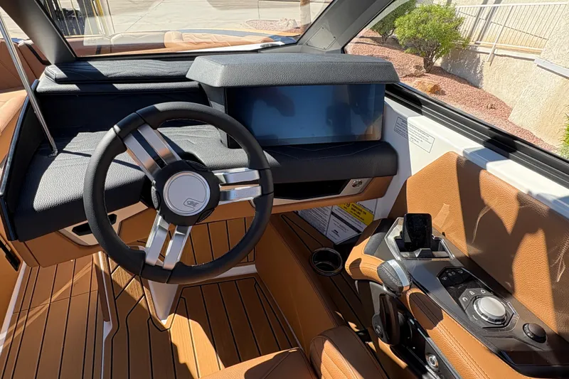 Slide: The Image of 2026 Nautique Super Air Nautique G25 helm with modern steering wheel and touchscreen display. - 10