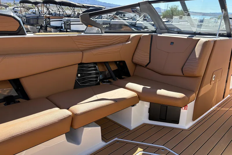 Slide: The Image of 2026 Nautique Super Air Nautique G25 interior with tan leather seating and sleek design. - 11