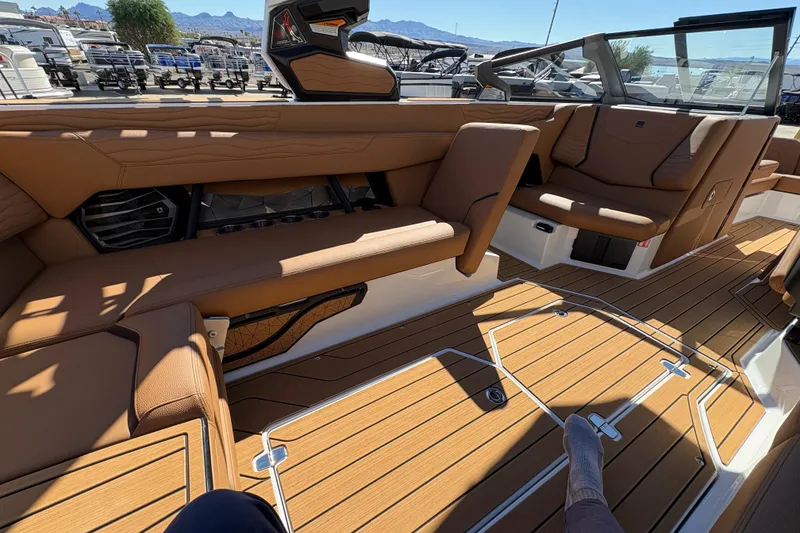 Slide: The Image of 2026 Nautique Super Air Nautique G25 interior with luxurious seating and teak flooring. - 12