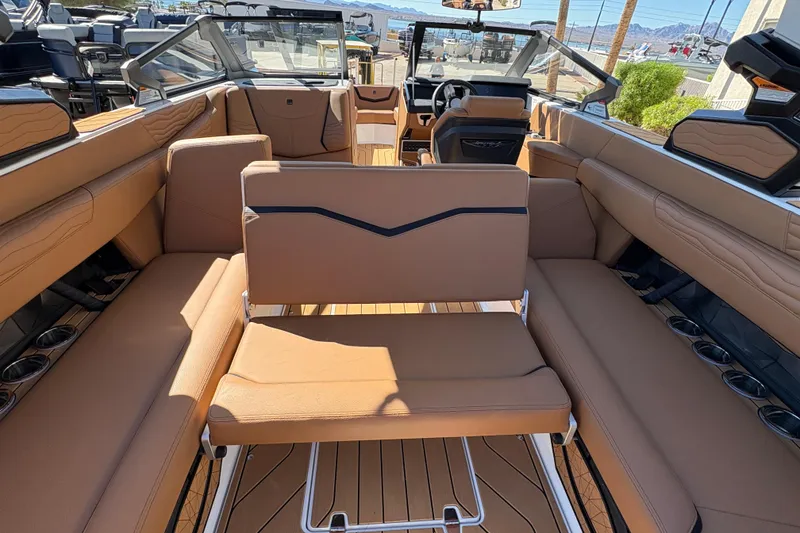 Slide: The Image of 2026 Nautique Super Air Nautique G25 interior with tan seating and modern design. - 14