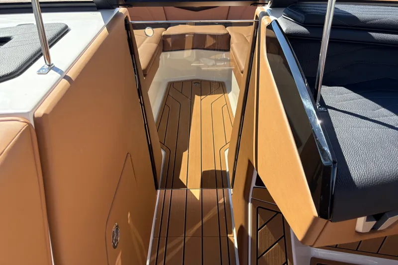 Slide: The Image of 2026 Nautique Super Air Nautique G25 interior with tan and black seating, sleek design. - 16