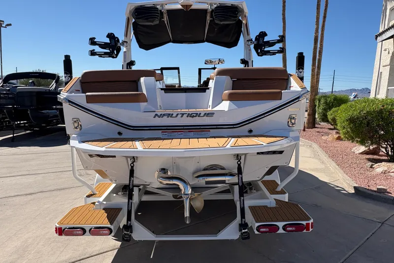Slide: The Image of 2026 Nautique Super Air Nautique G25 boat, rear view, showcasing deck and seating. - 5