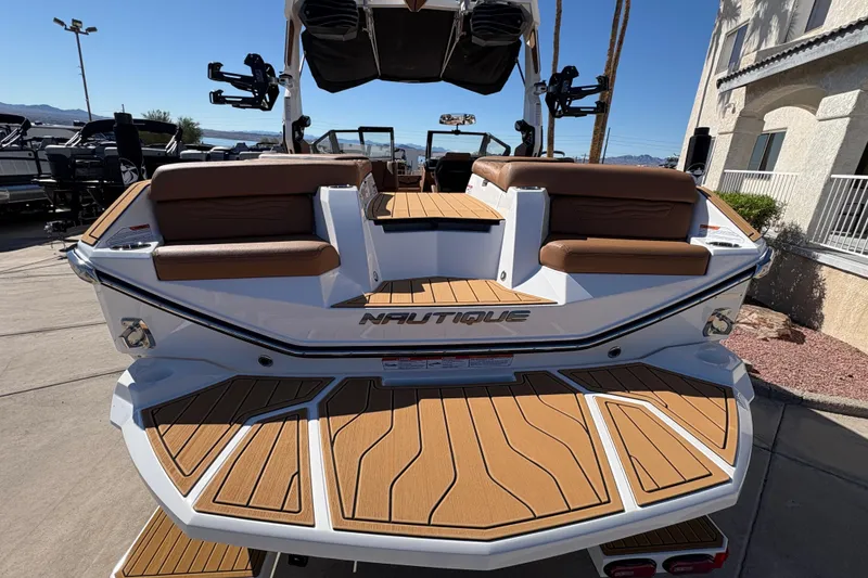 Slide: The Image of 2026 Nautique Super Air Nautique G25 boat with teak deck and brown seating. - 7