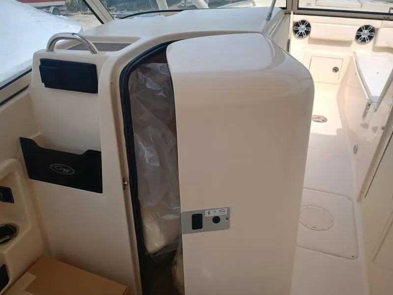 Slide: The Image of 2025 Grady-White Freedom 275 boat interior with storage compartment and seating area. - 11