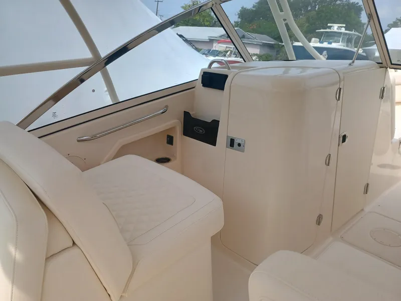 Slide: The Image of 2025 Grady-White Freedom 275 boat interior with beige seating and storage compartments. - 14