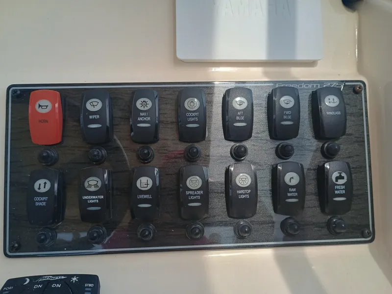Slide: The Image of Control panel of 2025 Grady-White Freedom 275 boat with labeled switches. - 18