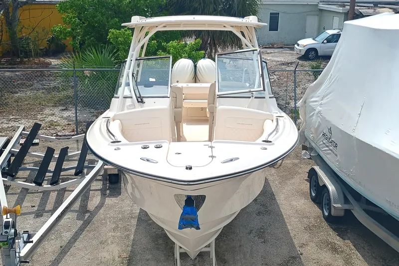 Slide: The Image of 2025 Grady-White Freedom 275 boat, docked outdoors, showcasing sleek design and spacious seating. - 4