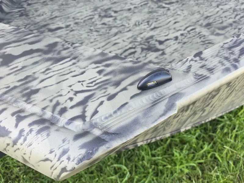 Slide: The Image of 2026 Tracker Grizzly® 1650 T Prairie Wings Edition boat with camouflage pattern on grass. - 10