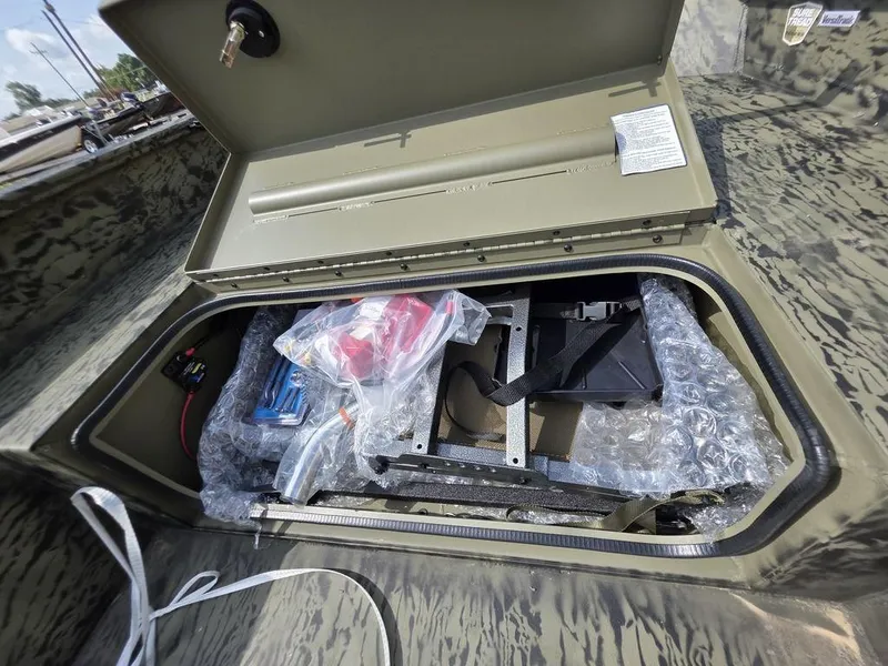 Slide: The Image of Open storage compartment in 2026 Tracker Grizzly® 1650 T Prairie Wings Edition boat. - 11