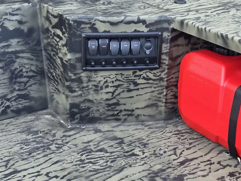 Slide: The Image of Control panel and red fuel tank on 2026 Tracker Grizzly® 1650 T Prairie Wings Edition boat. - 5