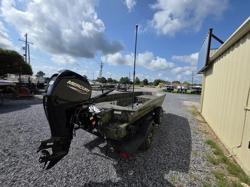 Slide: The Image of 2026 Tracker Grizzly® 1650 T Prairie Wings Edition boat with Mercury engine on gravel lot. - 6