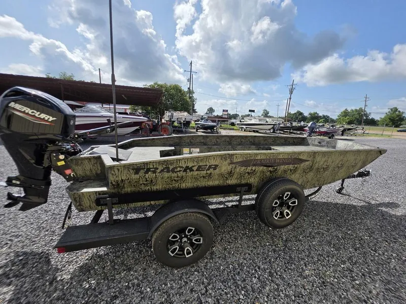 Slide: The Image of 2026 Tracker Grizzly® 1650 T Prairie Wings Edition boat on trailer, outdoors under cloudy sky. - 9