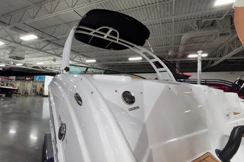 Slide: The Image of 2025 NauticStar 243 DC Deck boat in showroom, showcasing sleek design and modern features. - 22