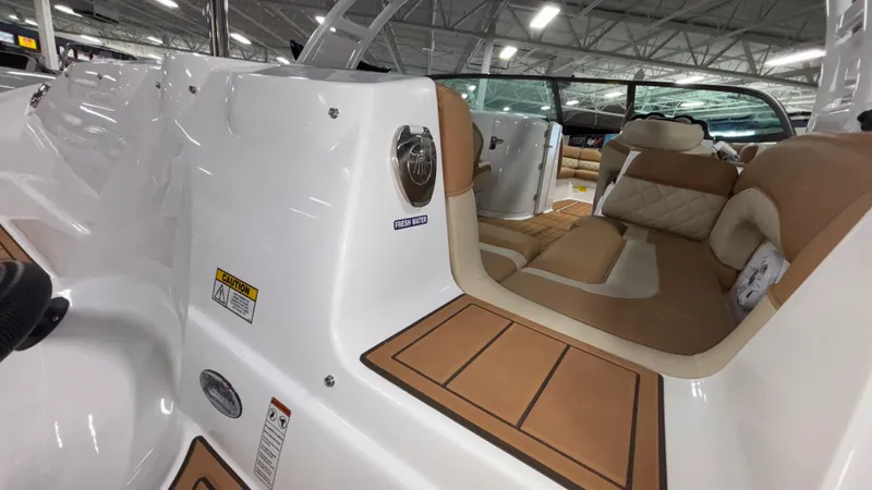 Slide: The Image of 2025 NauticStar 243 DC Deck boat interior with tan seating and modern design. - 4