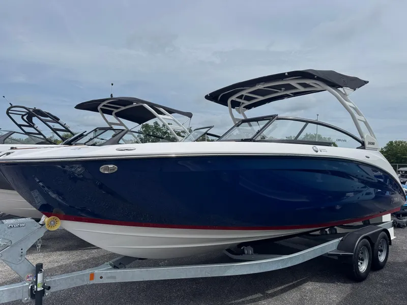 The Image of 2025 Yamaha Boats 252SD, sleek blue design, on trailer, ready for adventure. - 0