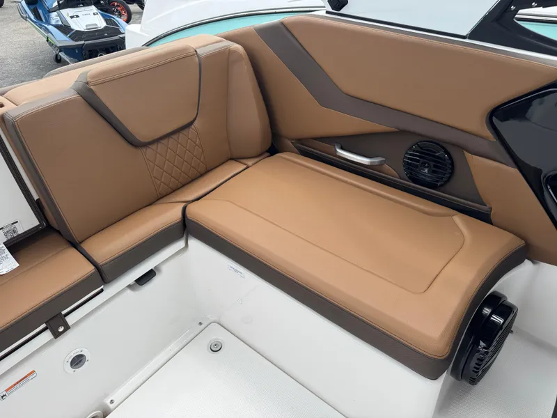 Slide: The Image of 2025 Yamaha Boats 252SD interior with tan leather seating and speaker system. - 19
