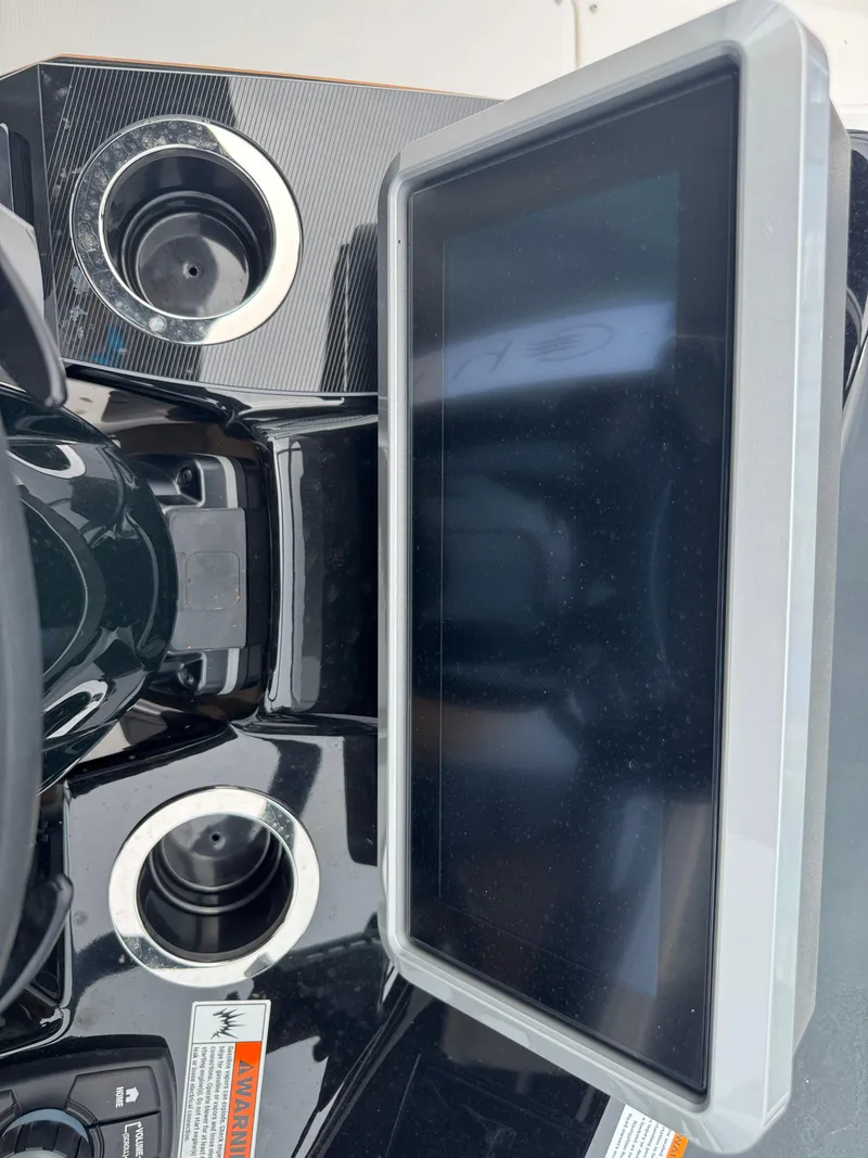 Slide: The Image of 2025 Yamaha Boats 252SD dashboard with touchscreen display and cup holders. - 27