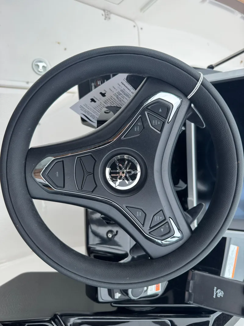 Slide: The Image of Steering wheel of 2025 Yamaha Boats 252SD, featuring modern controls and sleek design. - 28