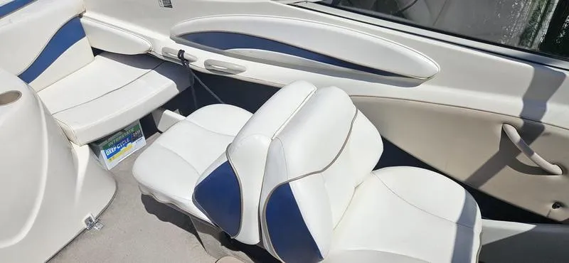 Slide: The Image of 2002 Bayliner 212 Capri Cuddy interior with white and blue seating. - 5