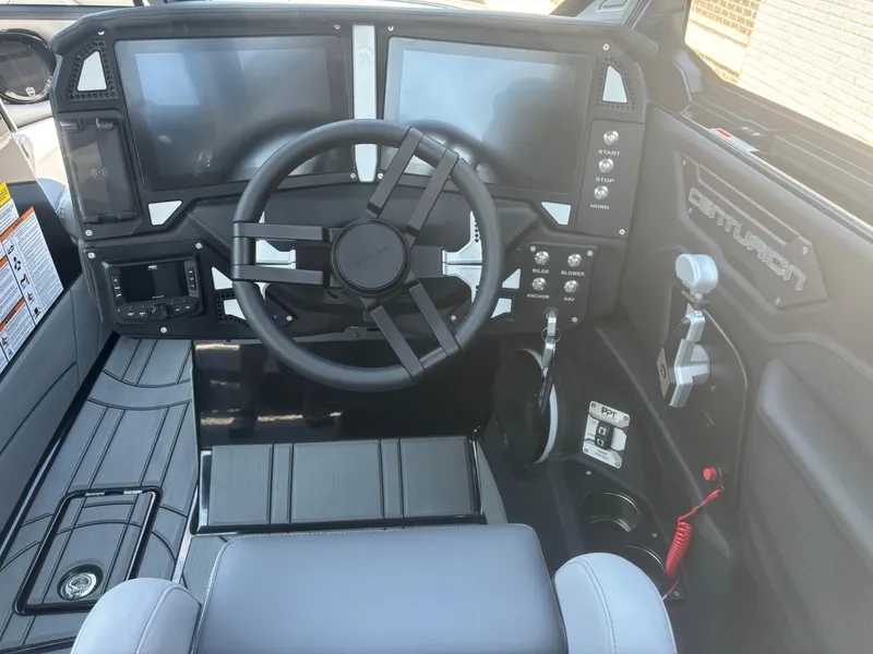 Slide: The Image of 2025 Centurion Ri245 boat dashboard with modern controls and dual screens. - 8