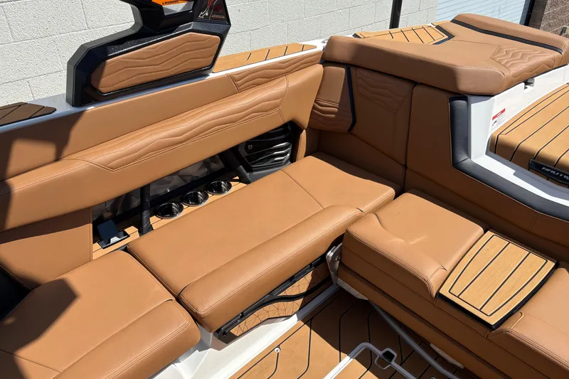 Slide: The Image of Luxurious tan interior of 2026 Nautique Super Air Nautique G23 boat. - 10