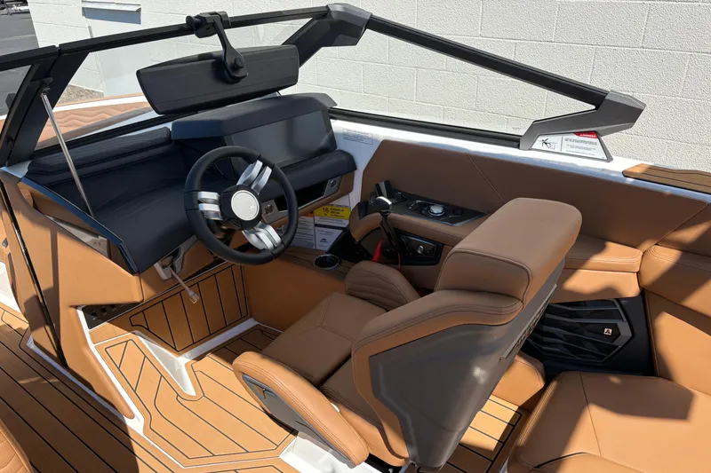 Slide: The Image of 2026 Nautique Super Air Nautique G23 interior with tan leather seats and modern steering wheel. - 12