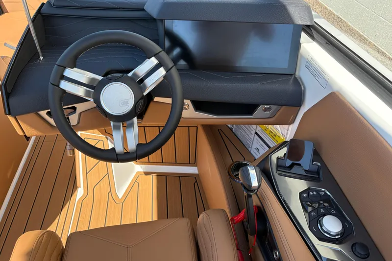 Slide: The Image of 2026 Nautique Super Air Nautique G23 cockpit with modern steering and control panel. - 13