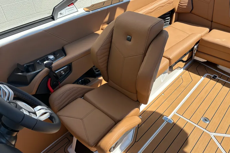 Slide: The Image of Luxurious interior of 2026 Nautique Super Air Nautique G23 boat with tan leather seating. - 14