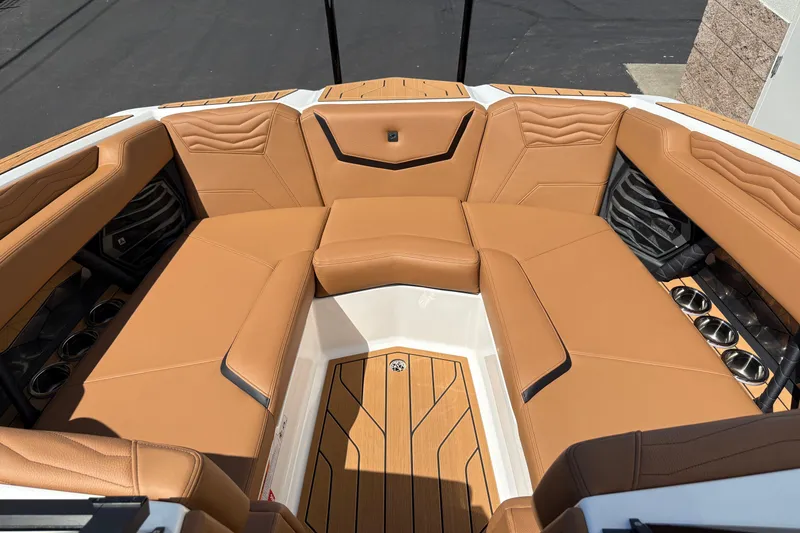 Slide: The Image of 2026 Nautique Super Air Nautique G23 boat interior with tan leather seating and wood flooring. - 15