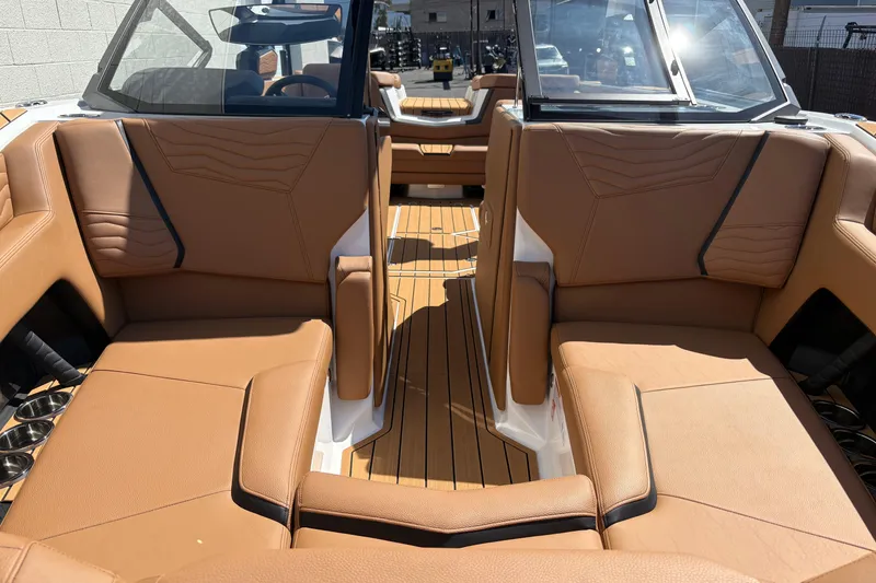 Slide: The Image of 2026 Nautique Super Air Nautique G23 interior with tan leather seating and sleek design. - 16