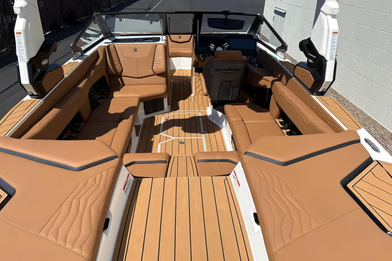 Slide: The Image of 2026 Nautique Super Air Nautique G23 interior with tan leather seating and sleek design. - 8