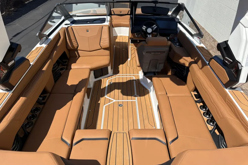 Slide: The Image of 2026 Nautique Super Air Nautique G23 interior with tan leather seating and sleek design. - 9