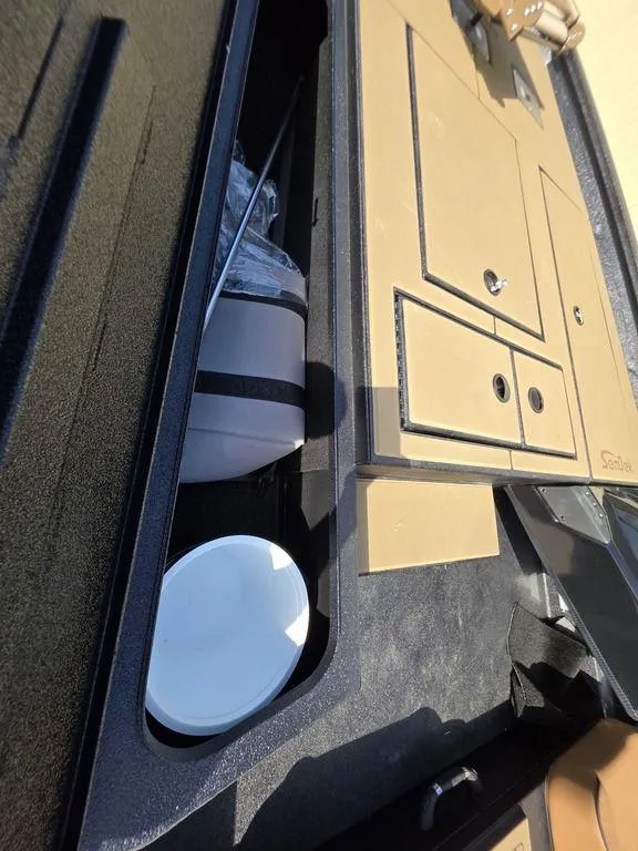 Slide: The Image of Storage compartment in 2026 Xpress H20C boat with organized equipment and supplies. - 10