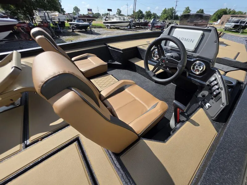 Slide: The Image of 2026 Xpress H20C boat interior with tan seats and Garmin navigation system. - 12
