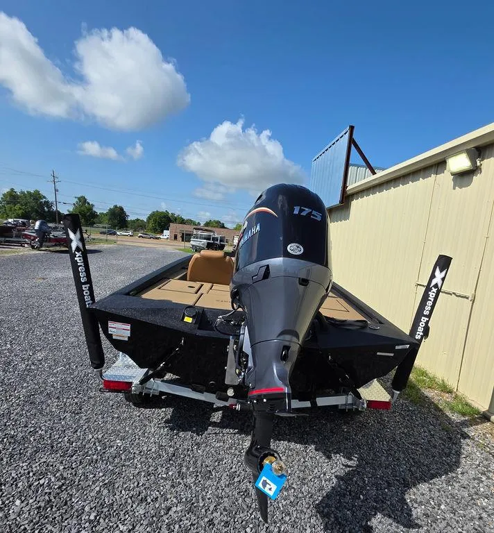 Slide: The Image of 2026 Xpress H20C boat with Yamaha 175 engine, parked on gravel near a building. - 15
