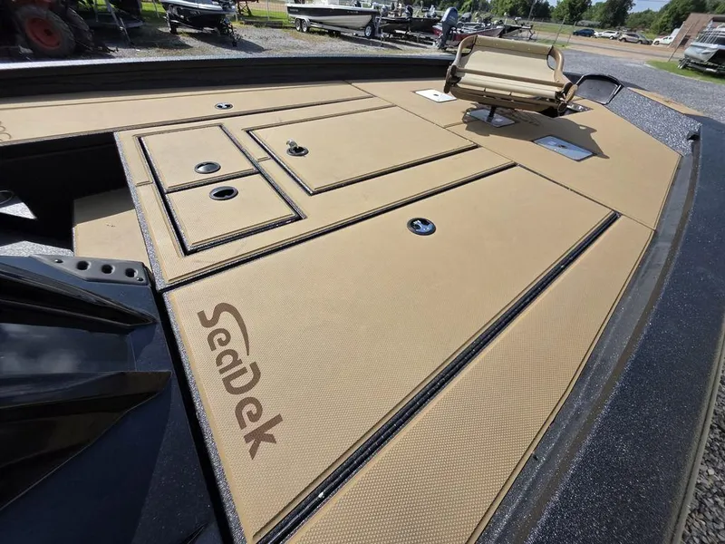Slide: The Image of 2026 Xpress H20C boat deck with tan SeaDek flooring and storage compartments. - 16