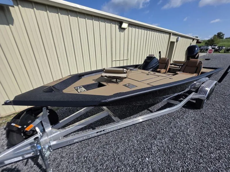 Slide: The Image of 2026 Xpress H20C boat on trailer, parked outdoors, under clear blue sky. - 4