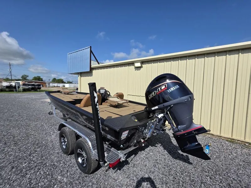 Slide: The Image of 2026 Xpress H20C boat with Yamaha engine on trailer, parked outdoors. - 5