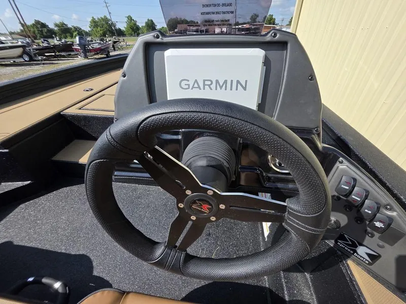 Slide: The Image of Steering wheel and Garmin display on 2026 Xpress H20C boat dashboard. - 8