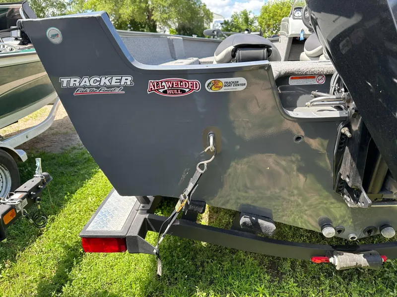 Slide: The Image of 2018 Tracker Pro Guide V-175 SC boat detail with Power Drive SS motor, under blue sky. - 21