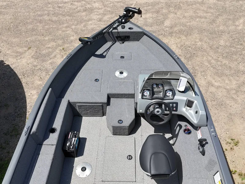 Slide: The Image of 2018 Tracker Pro Guide V-175 SC boat propeller and trailer on grass. - 6