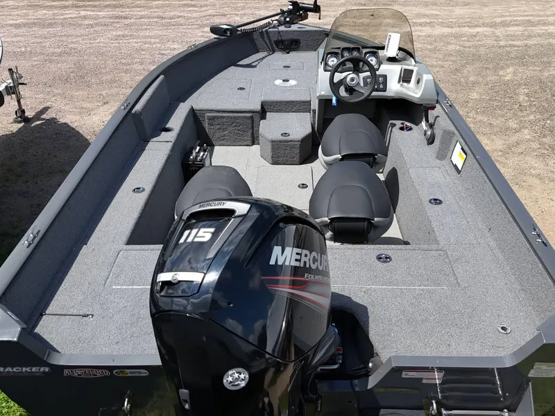 Slide: The Image of 2018 Tracker Pro Guide V-175 SC boat with motor and foldable ladder on grass. - 9