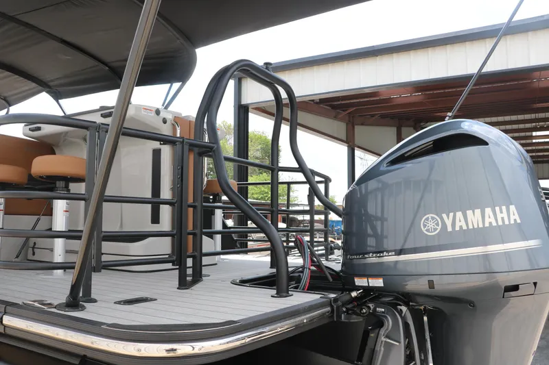 Slide: The Image of 2026 Sylvan G3 DLZ Bar pontoon boat with Yamaha outboard motor, docked under a canopy. - 12
