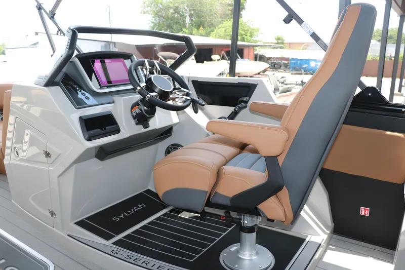 Slide: The Image of Captain's chair and helm of 2026 Sylvan G3 DLZ Bar boat, featuring modern controls and design. - 26