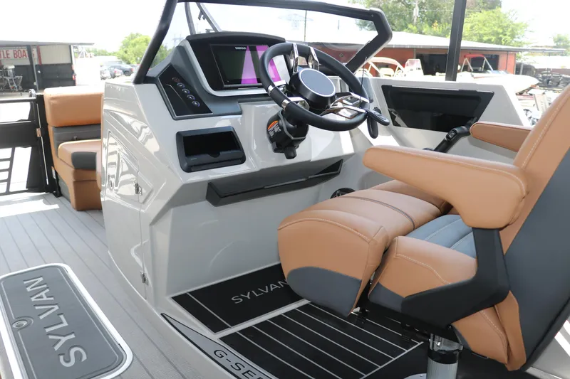 Slide: The Image of 2026 Sylvan G3 DLZ Bar boat interior with modern helm and tan seating. - 27