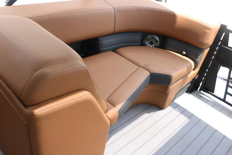 Slide: The Image of Luxurious tan seating on 2026 Sylvan G3 DLZ Bar boat, featuring sleek design and integrated speaker. - 29