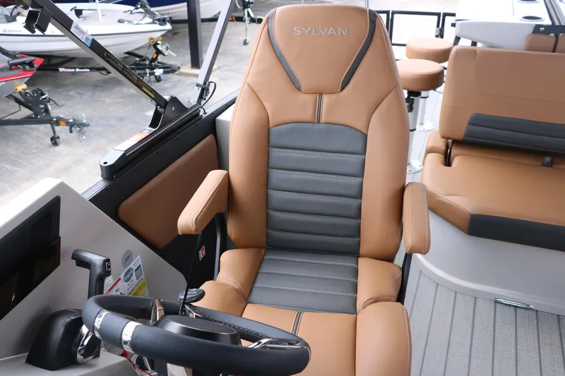 Slide: The Image of 2026 Sylvan G3 DLZ Bar boat interior with tan and gray captain's chair. - 37